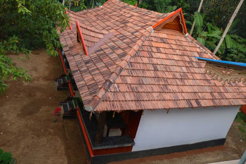 Tiled roof of the homestay among the trees