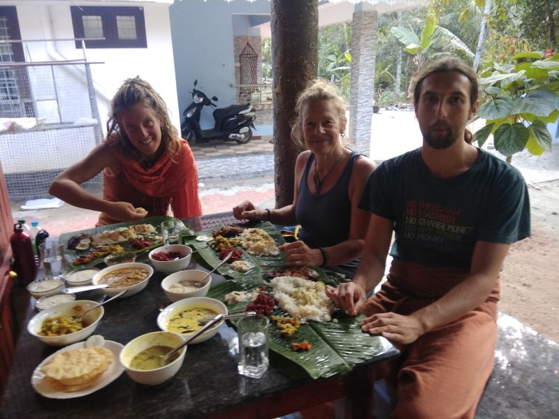 Guests sharing a Kerala meal on banana leaves